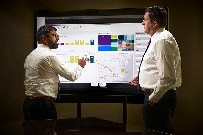 Two LEAD graduates discussing analytics.