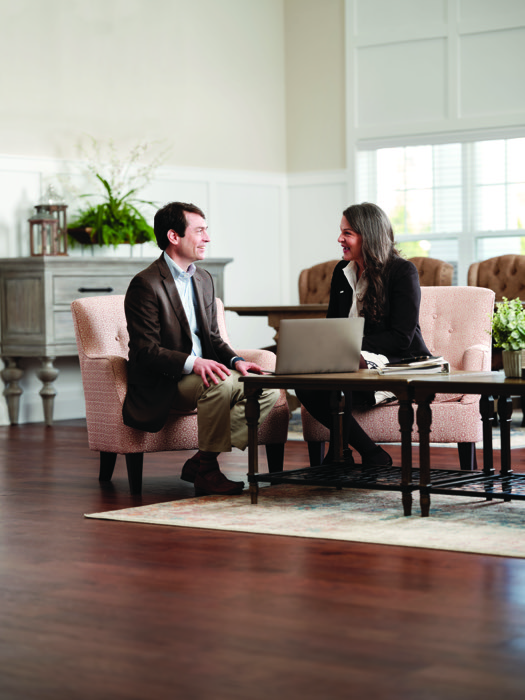 Brian Staub and Anne Conner talking while seated at a table.