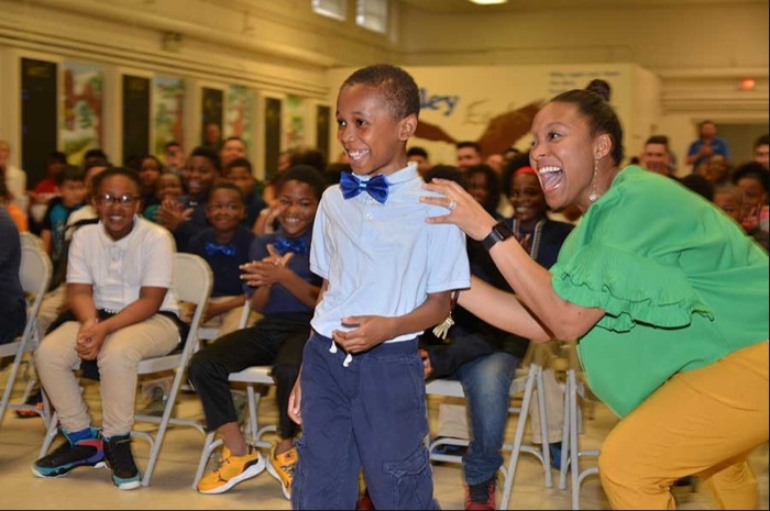 Mother and child smiling excitedly at a group event