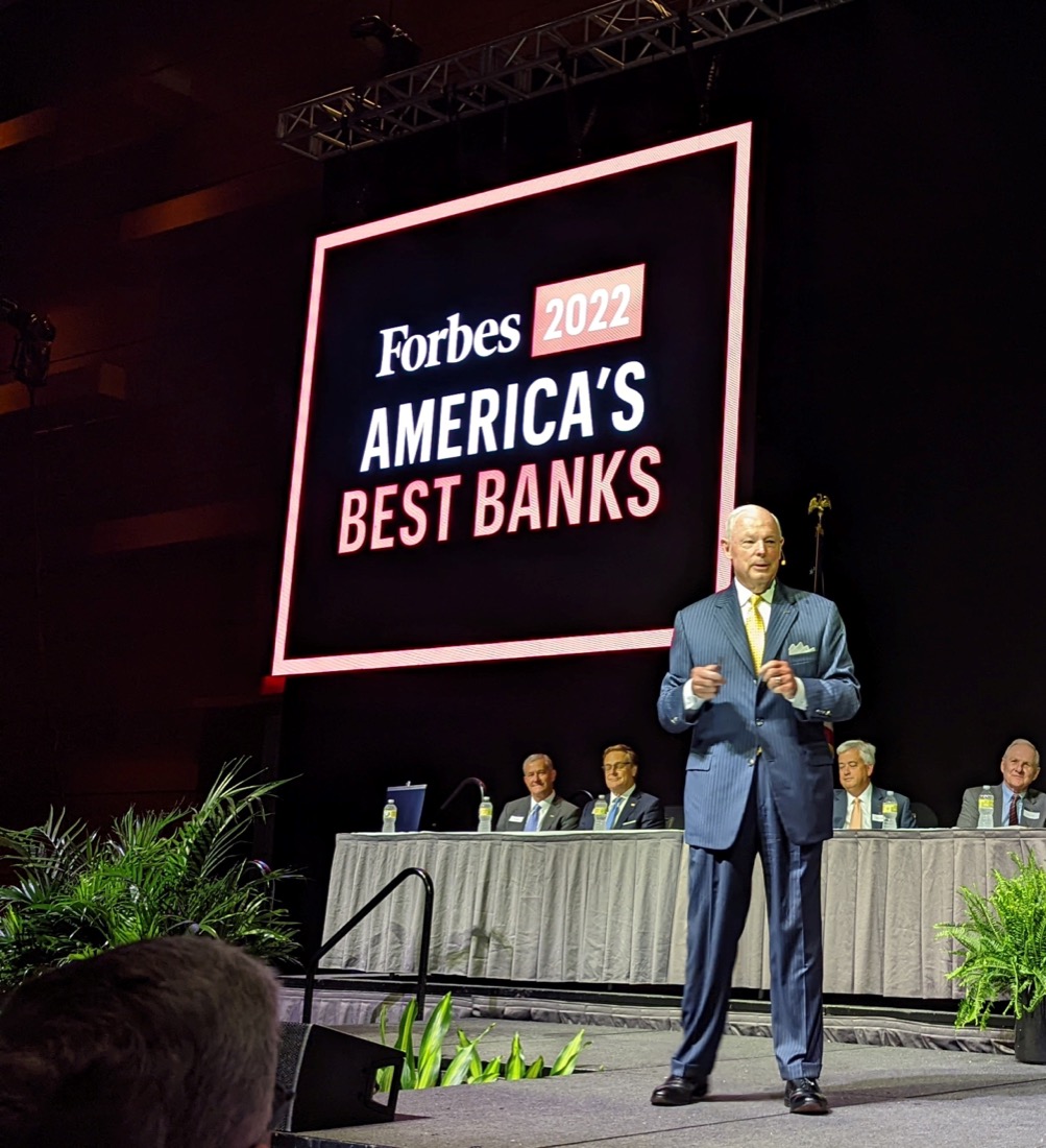 Photo of Bob Aston on stage speaking at an event