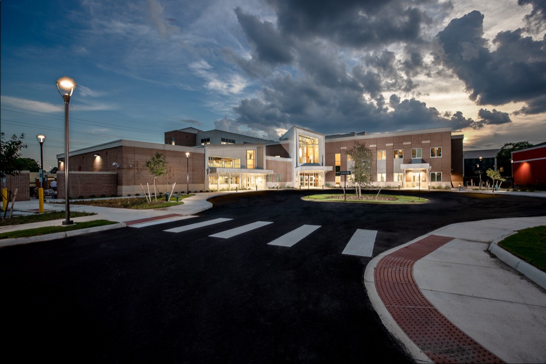 Exterior photo of large building at dusk.